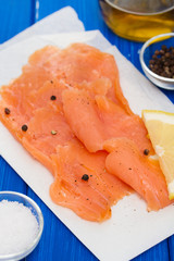 smoked salmon with lemon on white dish