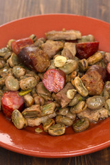 beans with meat and smoked sausages on ceramic dish