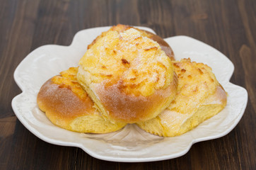 typical portuguese buns with coconut on white plate