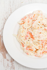 cabbage salad on white plate on wooden background