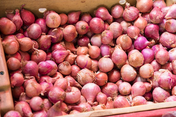 Red onions in basket in food market at Bangkok, Thailand.