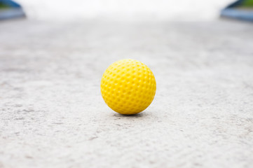Isolated yellow golf ball