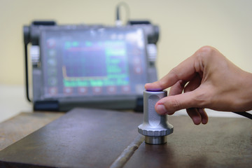 Inspector use ultrasonic testing machine for inspection defect in steel structure.
