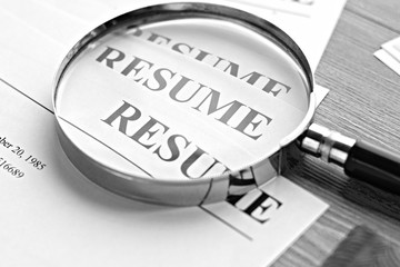 Resume (autobiography), pen, magnifier, laptop on your desktop. job search