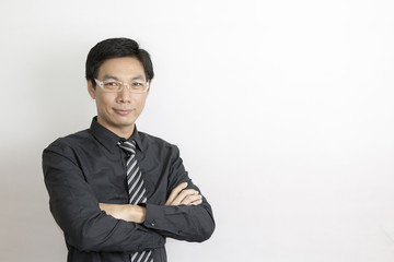 Asian businessman standing on grey background