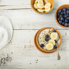 Obraz na płótnie Canvas Sweet milk porridge quinoa with honey and walnuts. Top view