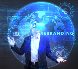 The concept of business, technology, the Internet and the network. A young entrepreneur working on a virtual screen of the future and sees the inscription: Rebranding