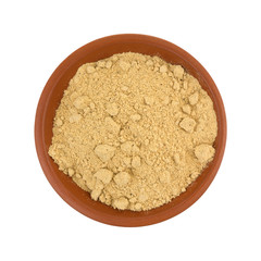 Top view of seasoning mix for beef stew in a small red clay bowl isolated on a white background.
