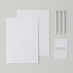Corporate stationery set mockup. Blank white brand ID elements, paper sheets, card, pencil. Top view. 3D rendering.