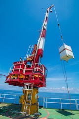 Fototapeta premium Pedestal crane, crane operator during operate crane with blue sky