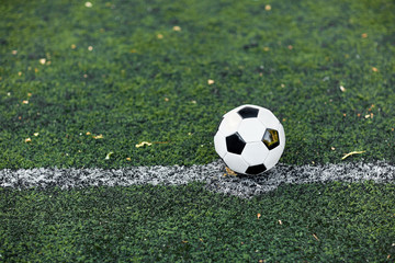 soccer ball on football field marking line