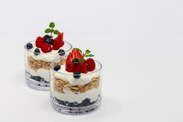 2 Glass jars of Greek yogurt isolated on white background.