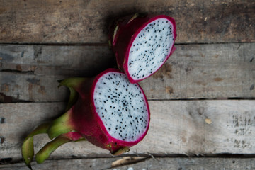 Closeup top view of dragon fruit isolated on old wooden table background