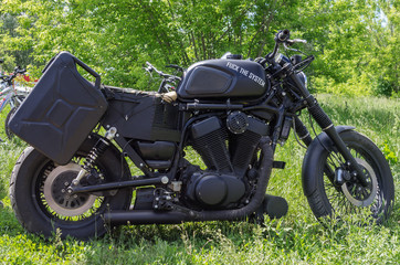 Naklejka premium Black homemade motorcycle with the inscription on the gas tank 