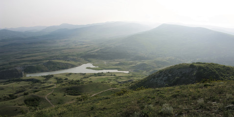 Lake among misty hills