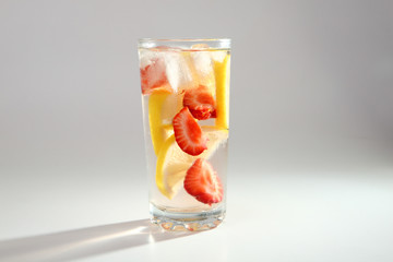 Cold cocktail with lemon and strawberries