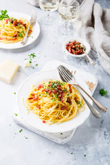 Italian pasta spaghetti Carbonara with fried bacon, parmesan cheese and parsley on white plate. Restaurant healthy food consept. Copy space.