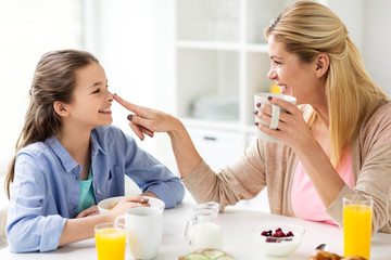 happy family having breakfast at home kitchen