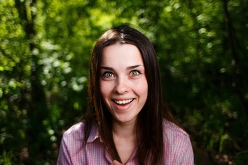  Portrait of surprised laughing cute young woman with wide smile