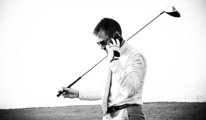 Golf player on the phone in black and white