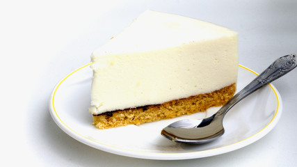 piece of cake bird's milk is on the plate on white background