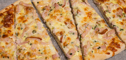 Close-up of Flammkuchen or Traditional Alsatian Pie, Tart Flambe Slices. Selective Focus.