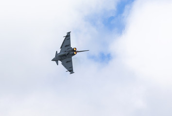 Modern jet fighter going full speed. Afterburner glowing orange.