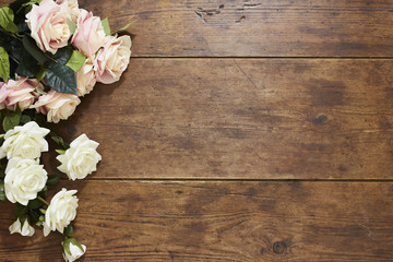 Roses on rustic wood background