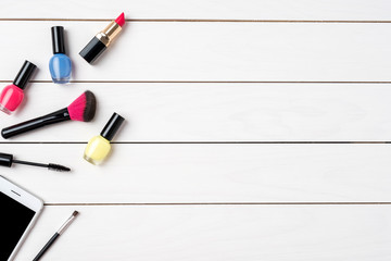 Makeup products on white wooden table. Beauty background