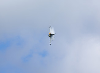 Cloud condensating on a jet fighter with afterburner on.