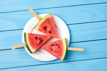 Watermelon slices on blue wooden table. Food background
