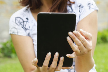 Tablet in women hands and blurred background
