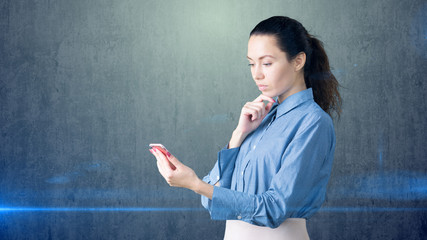 Portrait of young beautiful business woman with phone in her arms