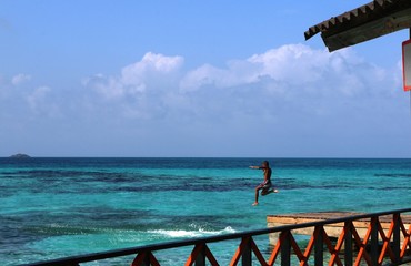 Boy jumping into the sea