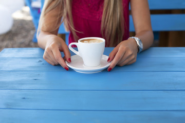 Urban young woman holding a cup of coffee