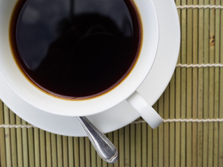 Coffee time, white cup of black coffee on table