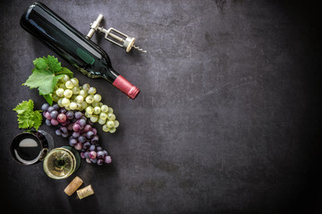 Bottle of wine, wineglasses, grapes and corks