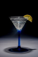 lemon in glass of soda bubbling 
