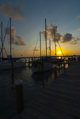 Fototapeta na wymiar sunrise over the marina with docked sailboats