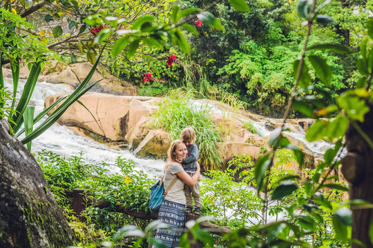 Mother and son on the background of Beautiful Camly waterfall In Da Lat city