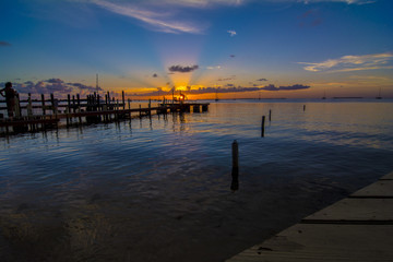 Obraz premium sunset behind long dock ocean 