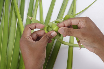 Making of Ketupat, a natural rice casing made from young coconut leaves for cooking rice