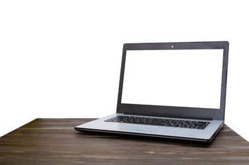 Laptop computer with white blank screen on wooden table with white background, selective focus, copy space