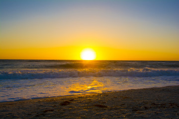 ocean sunset latge golden ball setting to ocean 