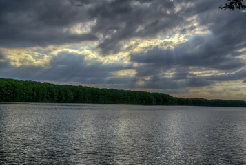 sun through clouds and pond
