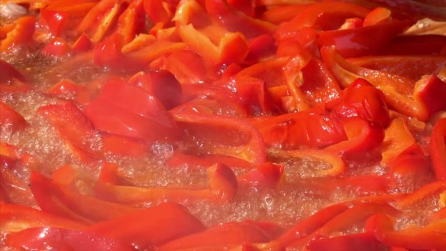 Chopped red peppers frying in oil at Chatuchak Weekend Market in Bangkok, Thailand