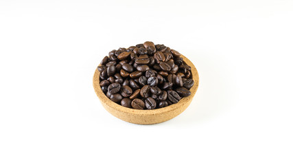 Preparing fresh roasted coffee beans in small wooden bowl on white background.