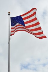 American flag waving in gloomy skies