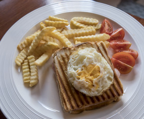 Fried egg on hot white buttered toast