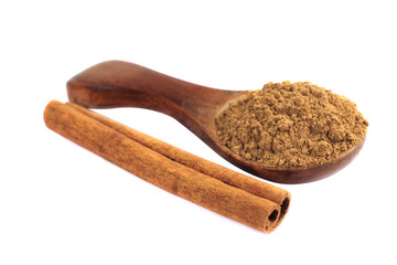Cinnamon in wooden spoon isolated on a white background